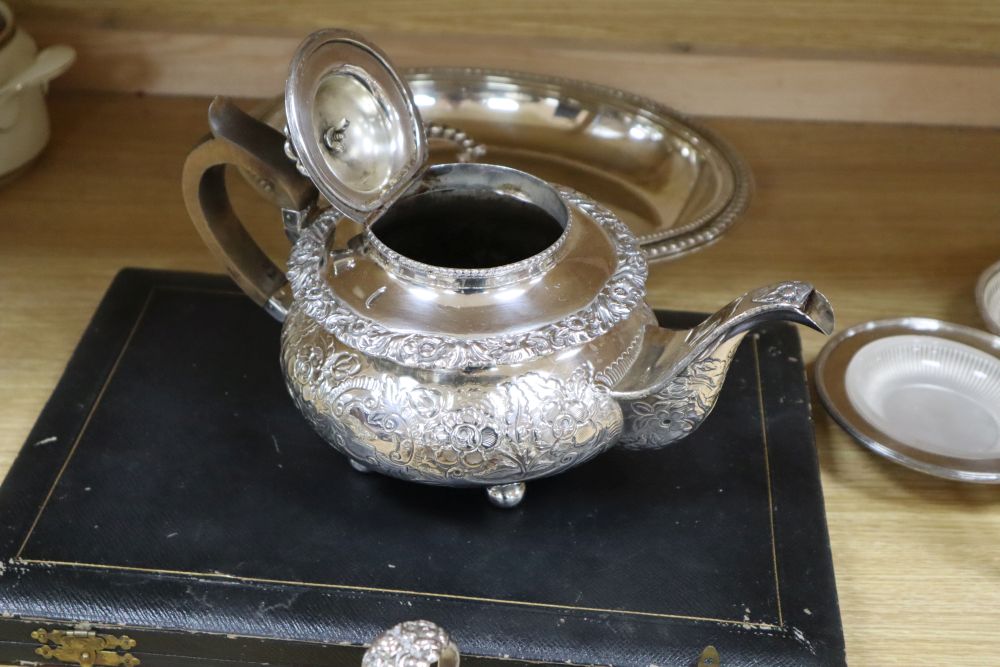 A cast and embossed silver plated teapot and matching milk jug, three plated card trays, etc.